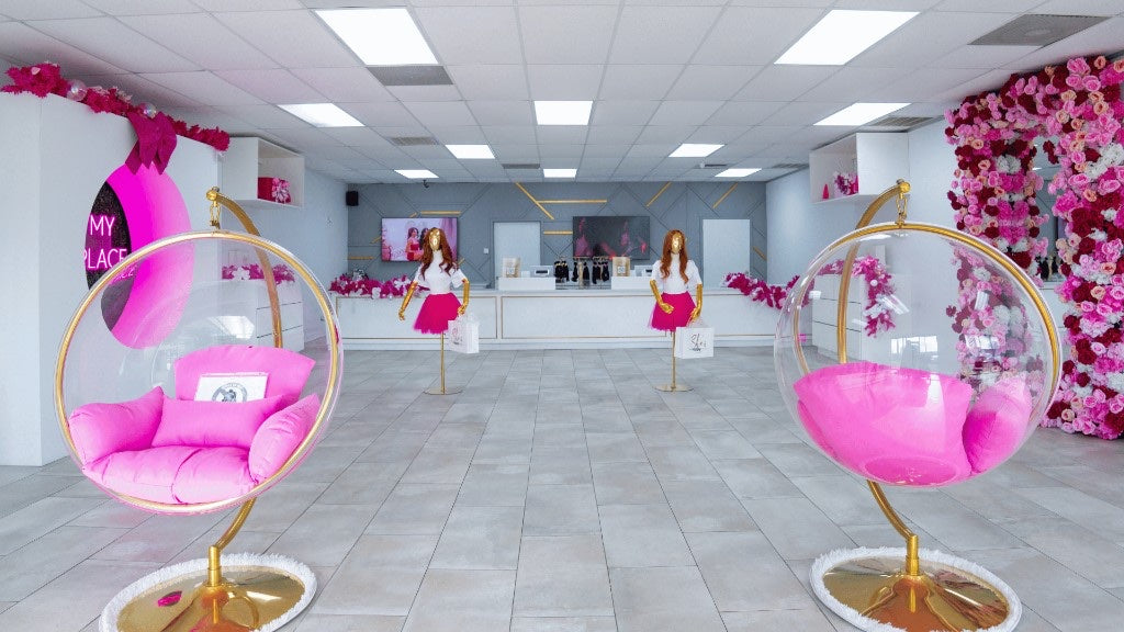 Houston North boutique floor with bubble chairs and a floral arch