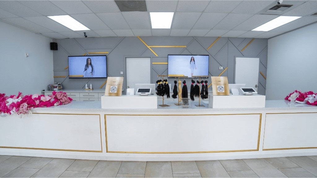 Wide product counter with hair stands inside Houston North