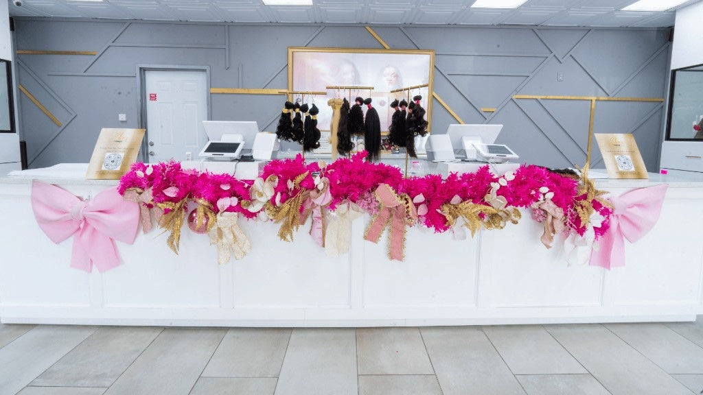 Houston South checkout counter with pink and gold garland and hair stands