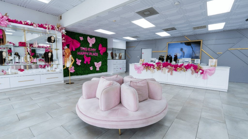 Houston South showroom overview with pink sofa, Happy Place wall, and checkout counter