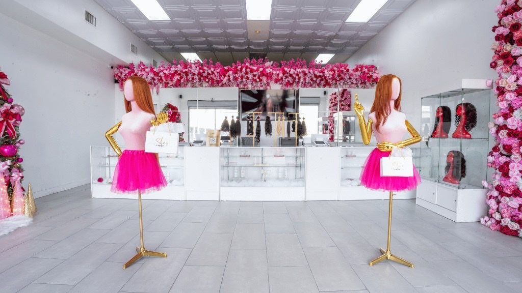 Twin mannequins and pink floral displays inside Houston Southwest
